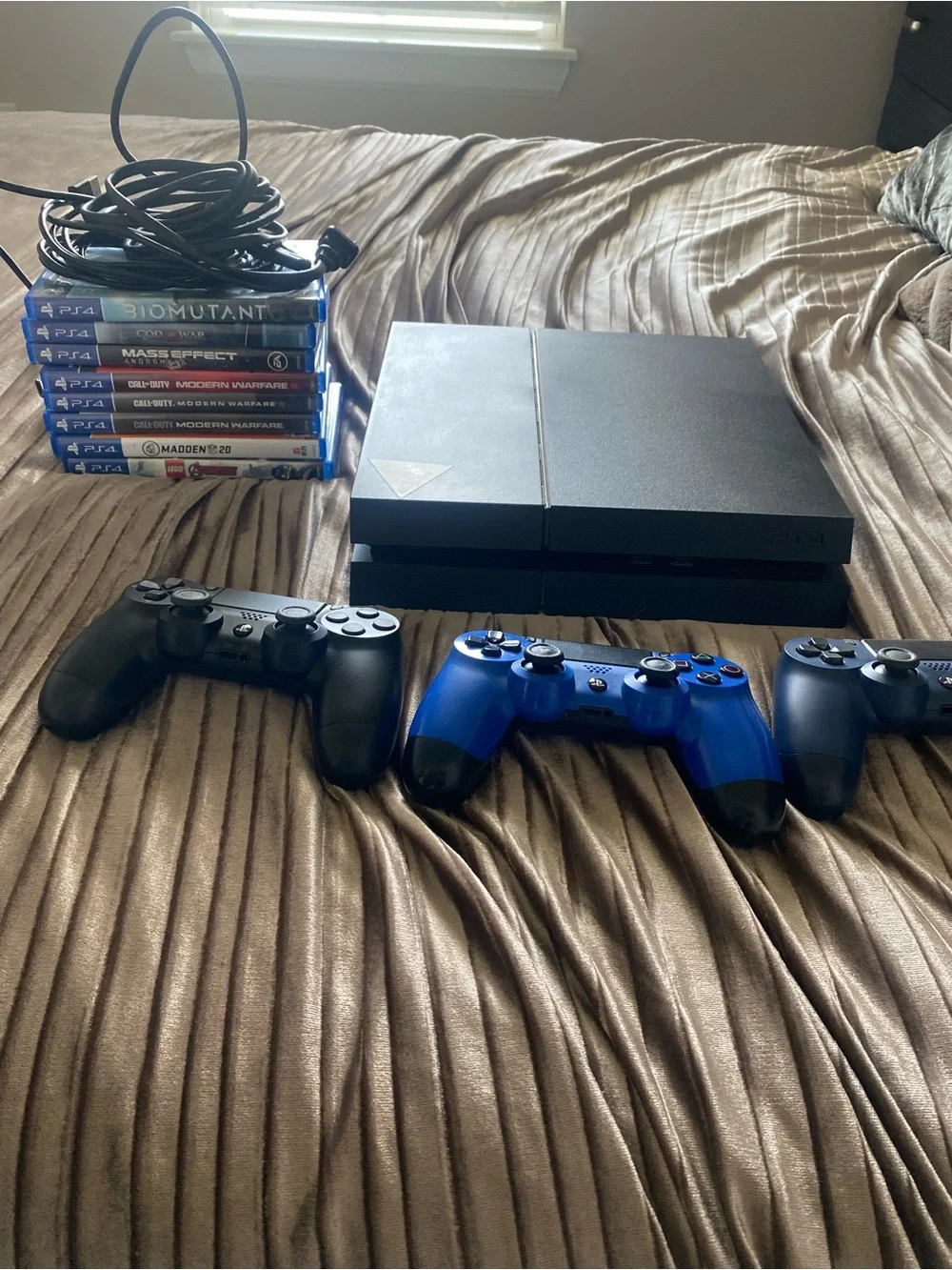 Sony PS4 Console with Black and Blue DualShock Controllers and Game Stack